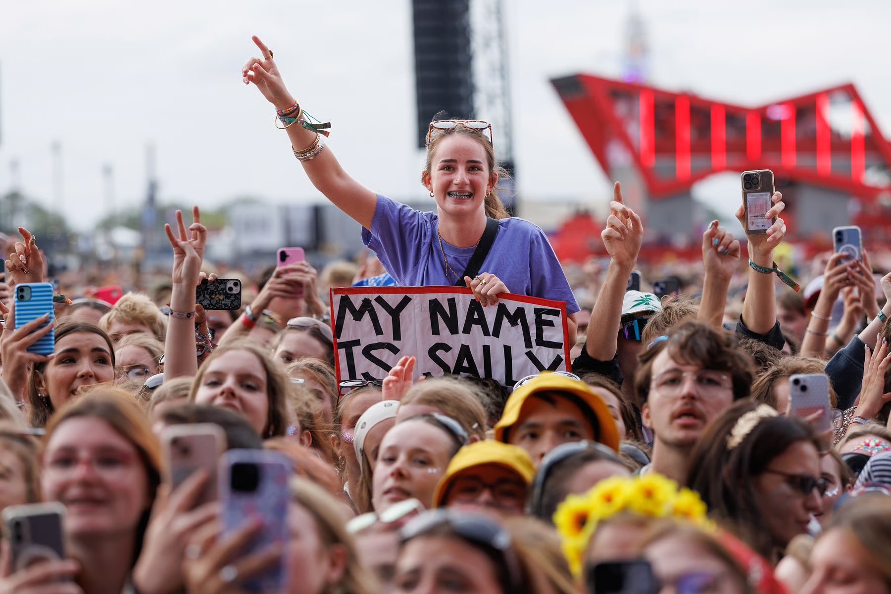 Packed Leeds crowd with a handmade sign held above heads